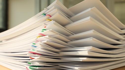 A large stack of papers with paperclips