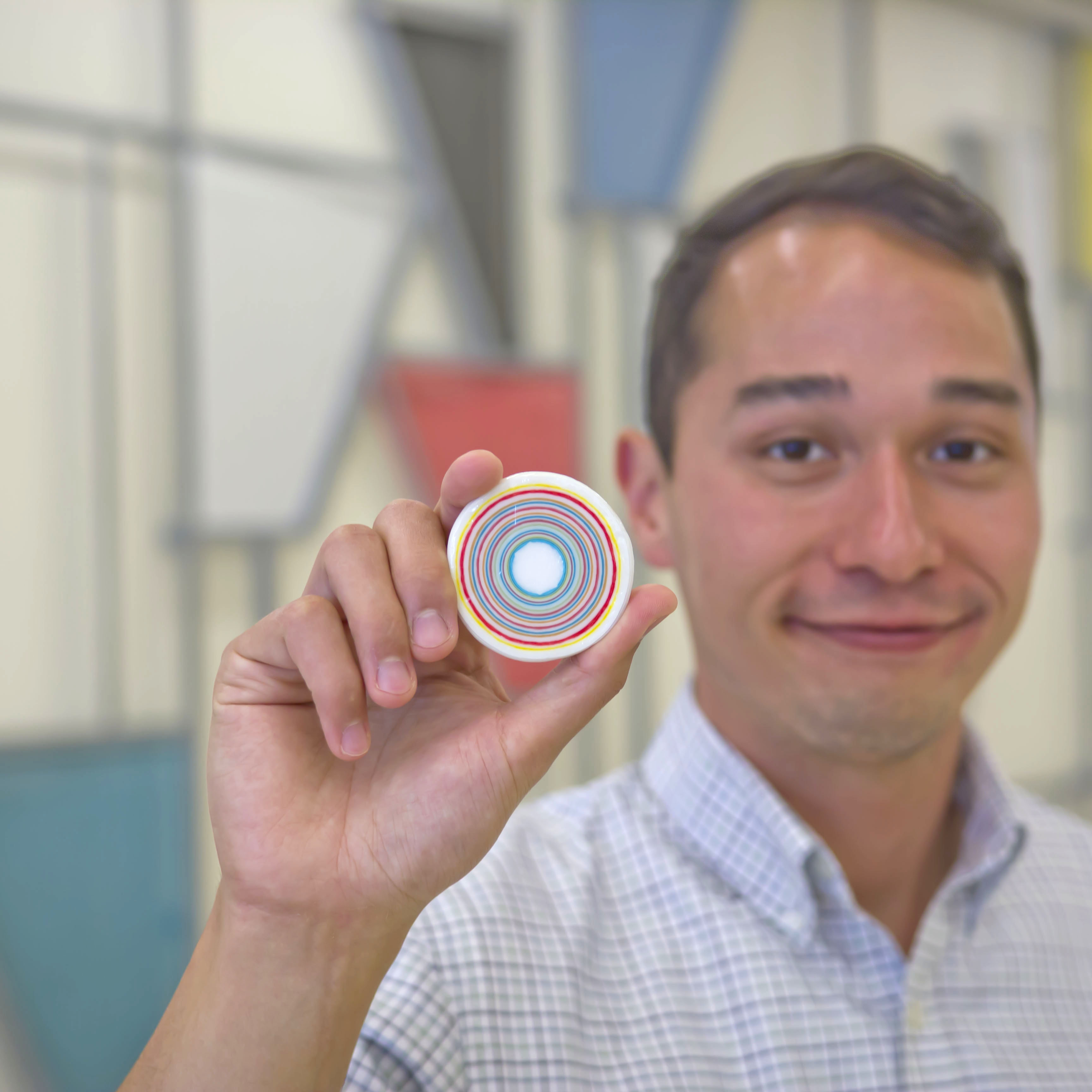 photo of researcher holding model of layer-by-layer nanoparticle