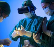 Three doctors using virtual reality for patient surgery