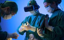 Three doctors using virtual reality for patient surgery