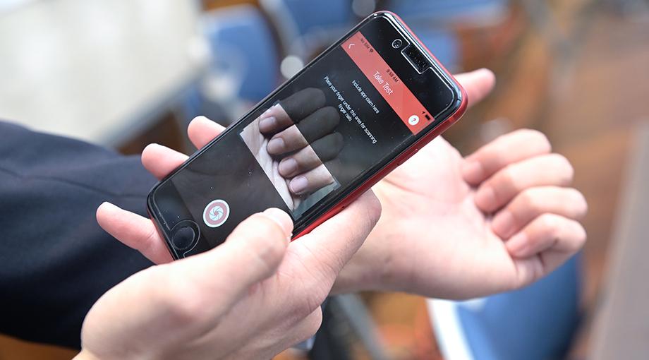 Participants try out an app developed by researchers at Georgia Tech and Emory University that measures hemoglobin by taking an image of the fingernails.