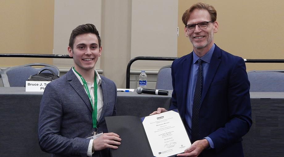 Standard student Mark Buckup was part of a team that developed a device to detect peritonitis earlier than the current standard of care. Dr. Bruce Tromberg awards the team a Honorable Mention prize.