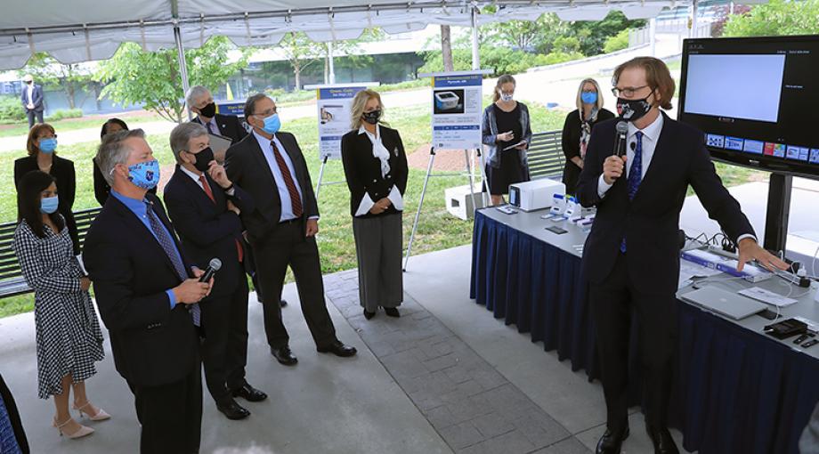 NIBIB Director Bruce Tromberg demonstrates Ellume COVID-19 antigen test developed with support from NIH RADx Tech/ATP. (NIH photo by Chia-Chi Charlie Chang)