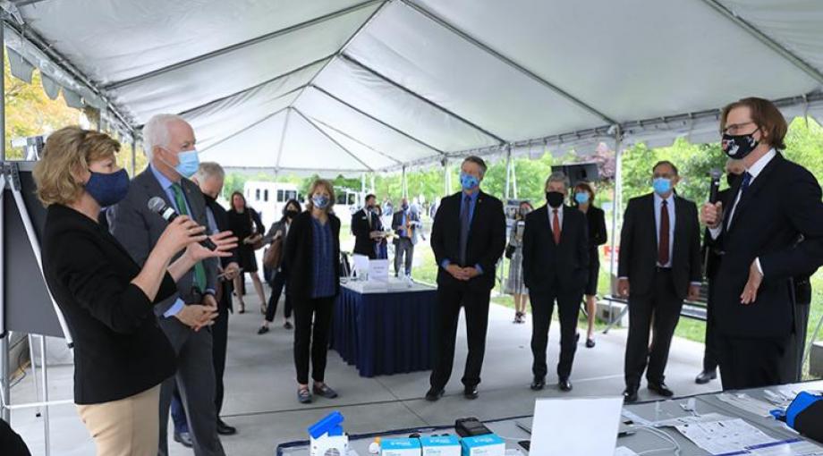 From left, Senators Tammy Baldwin (Wisconsin), John Cornyn (Texas), Chris Van Hollen (Maryland), Lisa Murkowski (Alaska), Roger Marshall (Kansas), Roy Blunt, (Missouri), and John Boozman (Arkansas) discuss diagnostics tech with NIBIB Director Bruce Tromberg. (NIH photo by Chia-Chi Charlie Chang)