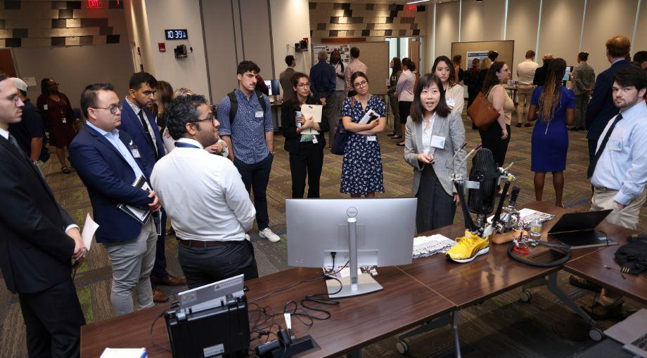 He (Helen) Huang (center) describes how their technology can help to restore balance and stability among amputees with lower-limb loss.