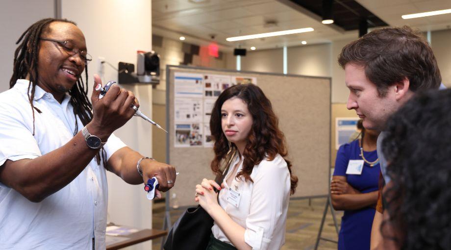 Manu Platt demonstrates how a pipette can be used to accurately dispense tiny amounts of liquid for gel electrophoresis experiments.