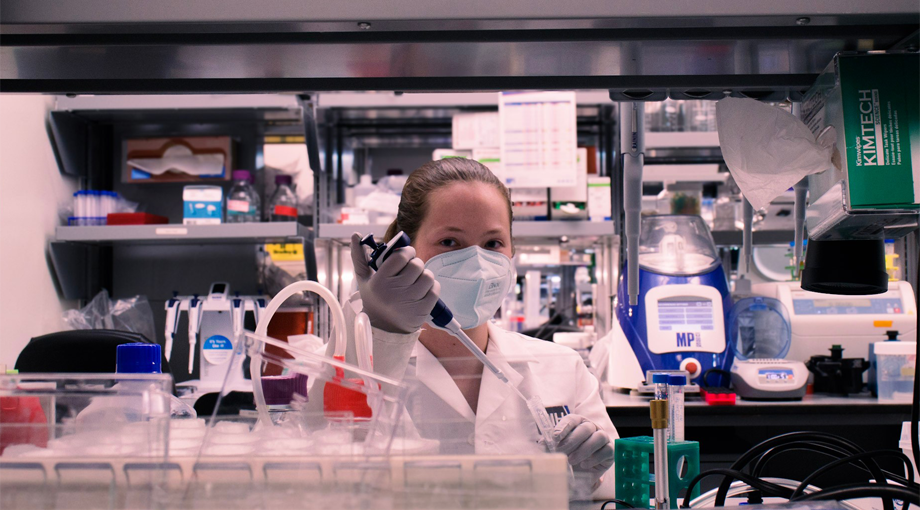 A photo of Maya Evohr holding a pipette in the MATRICES lab