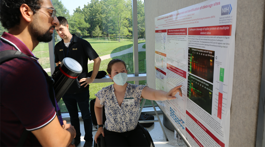 A photo of intern Maya Evohr presenting her scientific poster